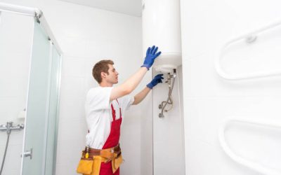 Professional plumber checking a boiler and pipes, boiler service concept